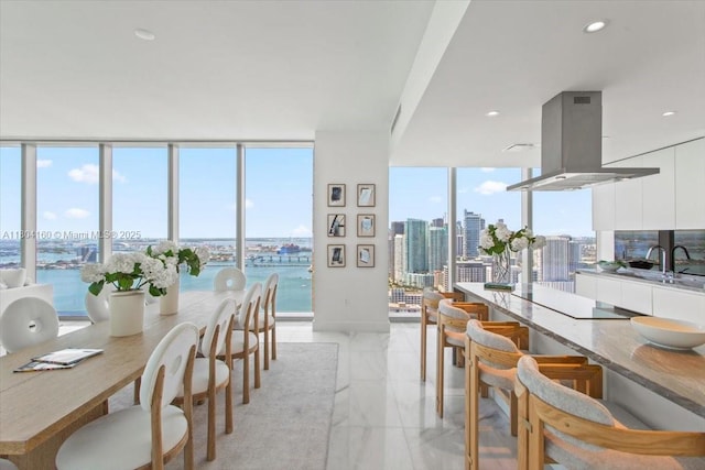 700 NE 26th Ter Unit 3903, Miami, FL 33137 - dining area with expansive windows, a view of city, light marble finish floors, a water view, and recessed lighting
