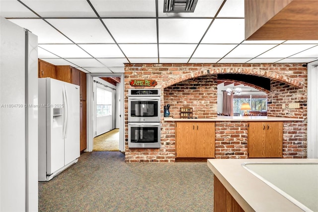 21800 SW 152nd Ave, Miami, FL 33170 - kitchen with white refrigerator with ice dispenser, stainless steel double oven, carpet floors, light countertops, and a paneled ceiling