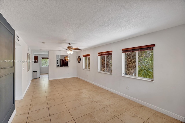 6235 SW 47th Mnr Unit 204, Davie, FL 33314 - empty room with a textured ceiling, ceiling fan, light tile patterned flooring, and baseboards