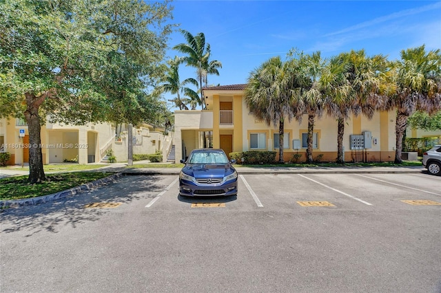 6235 SW 47th Mnr Unit 204, Davie, FL 33314 - view of property with uncovered parking and stairs