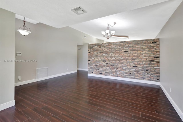 18225 NW 21st St, Pembroke Pines, FL 33029 - spare room with a chandelier, baseboards, brick wall, wood finished floors, and vaulted ceiling