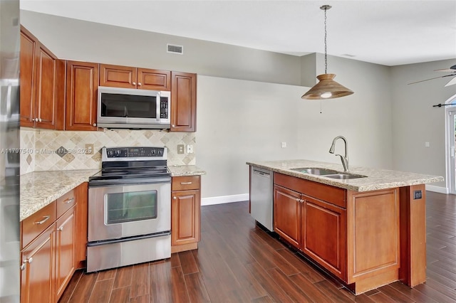 18225 NW 21st St, Pembroke Pines, FL 33029 - kitchen featuring stainless steel appliances, a sink, backsplash, dark wood-type flooring, and baseboards