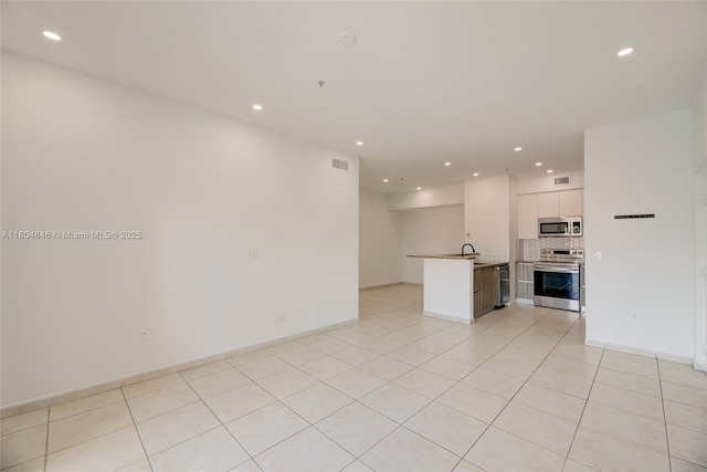 7330 NW 114th Ave Unit 304-5, Doral, FL 33178 - unfurnished living room featuring recessed lighting, light tile patterned floors, a sink, and baseboards