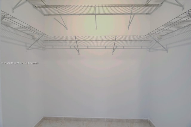7330 NW 114th Ave Unit 304-5, Doral, FL 33178 - walk in closet with light tile patterned floors