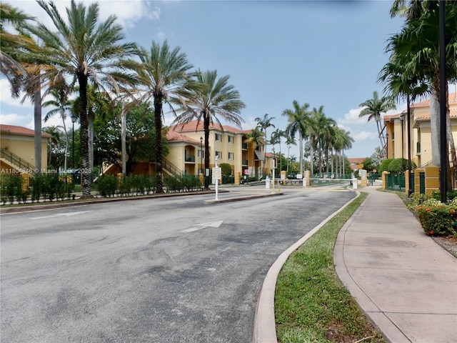 7330 NW 114th Ave Unit 304-5, Doral, FL 33178 - view of asphalt road with sidewalks, curbs, and a residential view