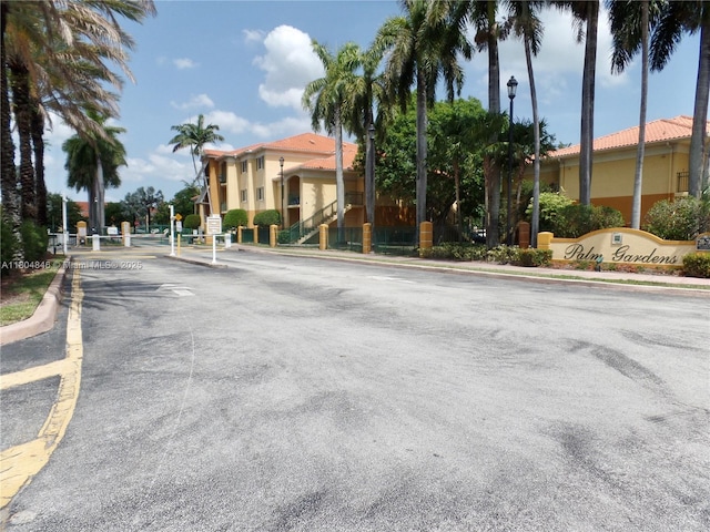 7330 NW 114th Ave Unit 304-5, Doral, FL 33178 - view of asphalt road with street lights, curbs, and a gated entry
