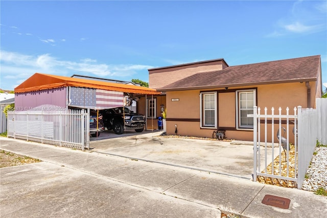 19251 SW 118th Ct, Miami, FL 33177 - back of property with fence, stucco siding, roof with shingles, and concrete driveway