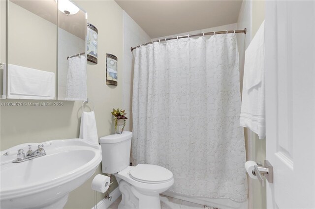 19251 SW 118th Ct, Miami, FL 33177 - bathroom featuring a sink, toilet, a shower with shower curtain, and tile patterned flooring