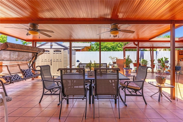 19251 SW 118th Ct, Miami, FL 33177 - view of patio featuring ceiling fan, outdoor dining space, a storage unit, and fence