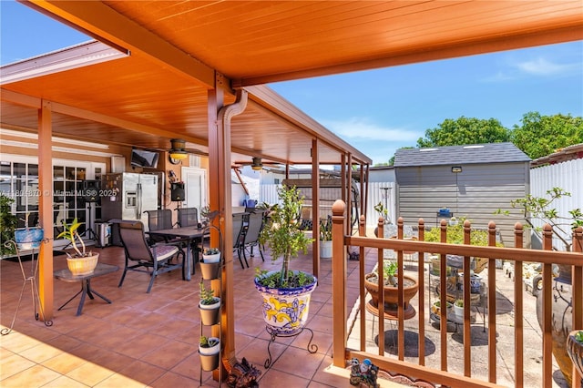 19251 SW 118th Ct, Miami, FL 33177 - view of patio featuring fence, an outdoor structure, a storage shed, and outdoor dining space