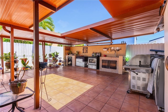 19251 SW 118th Ct, Miami, FL 33177 - view of patio featuring exterior kitchen, a fenced backyard, and a grill
