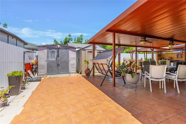19251 SW 118th Ct, Miami, FL 33177 - view of patio / terrace with a storage unit, a fenced backyard, outdoor dining area, an outbuilding, and ceiling fan