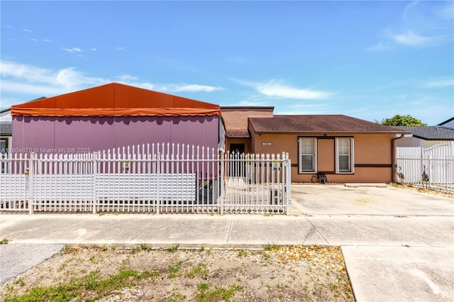 19251 SW 118th Ct, Miami, FL 33177 - view of front facade with stucco siding and a fenced front yard