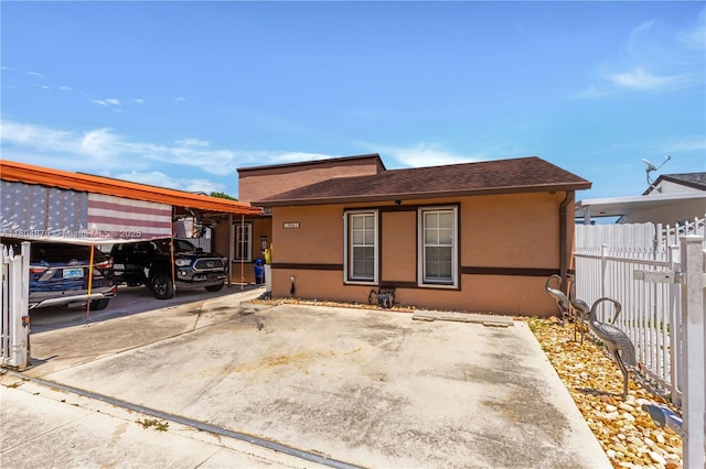 19251 SW 118th Ct, Miami, FL 33177 - view of front facade featuring fence, a carport, stucco siding, and a shingled roof
