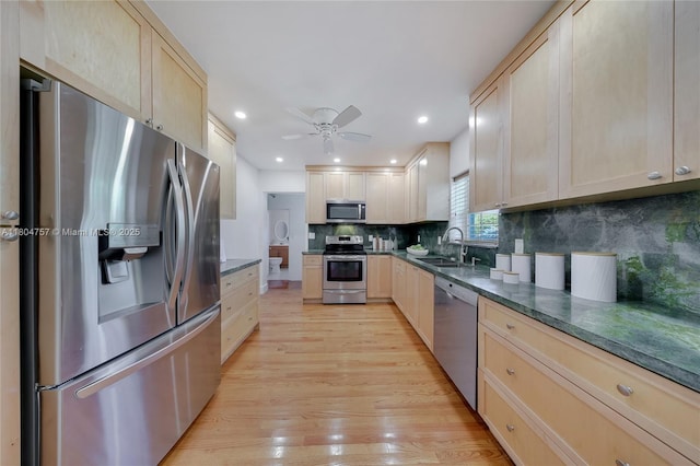 13521 S Biscayne River Rd, Miami, FL 33161 - kitchen featuring stainless steel appliances, light brown cabinetry, dark countertops, light wood finished floors, and backsplash