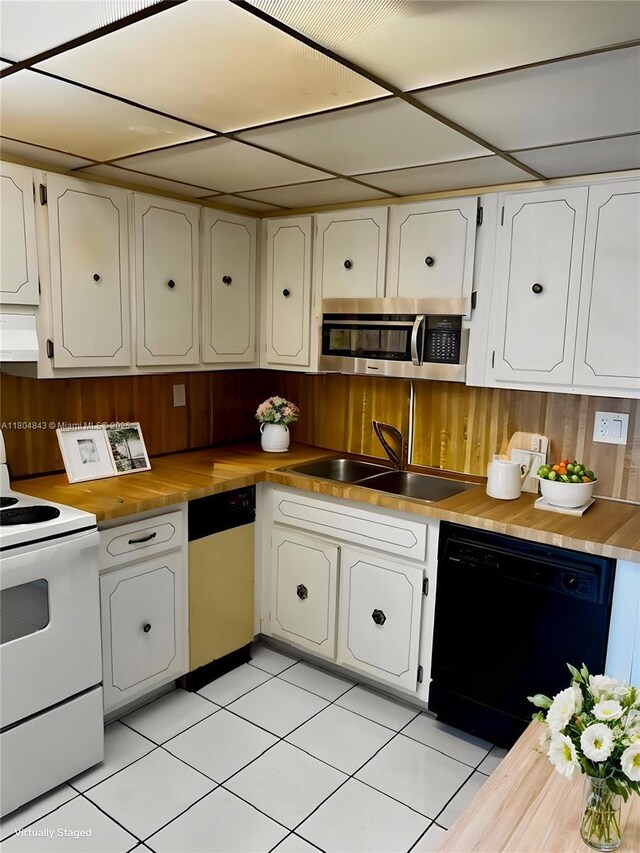 5731 NW 37th St Unit 206, Virginia Gardens, FL 33166 - kitchen featuring dishwashing machine, white electric range, a sink, butcher block counters, and stainless steel microwave