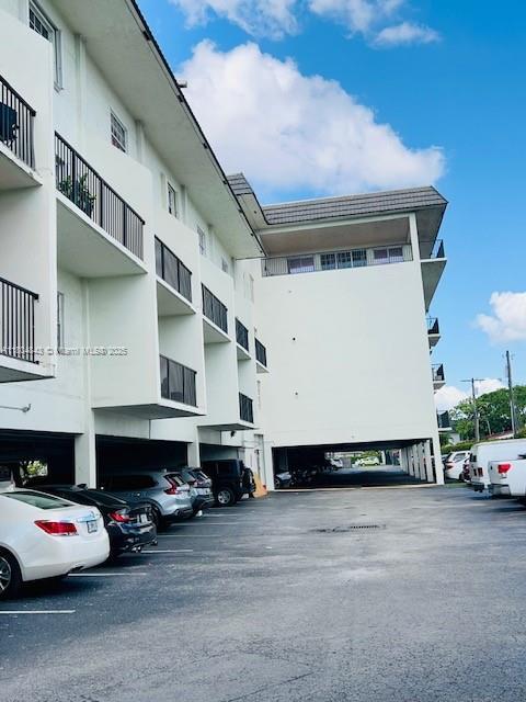 5731 NW 37th St Unit 206, Virginia Gardens, FL 33166 - view of apartment building / complex featuring covered parking