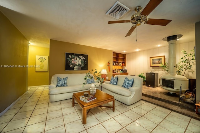 7505 SW 167th St, Palmetto Bay, FL 33157 - tiled living room featuring a wood stove, a ceiling fan, built in shelves, and baseboards