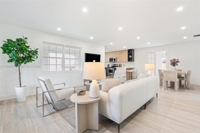 6845 SW 12th St, Pembroke Pines, FL 33023 - living room with baseboards, light wood finished floors, and recessed lighting