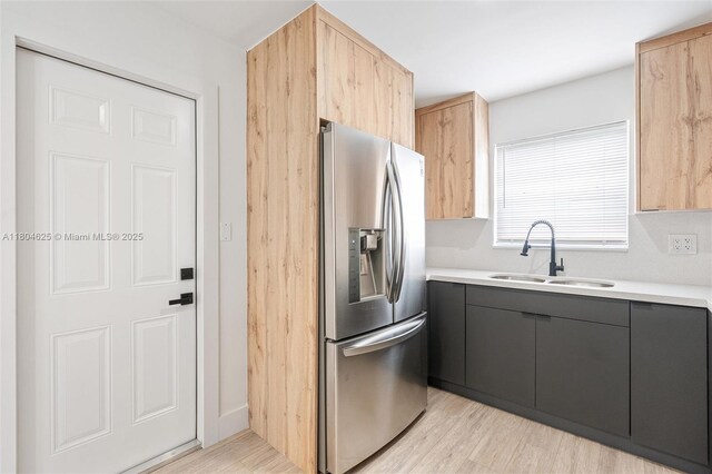 6845 SW 12th St, Pembroke Pines, FL 33023 - kitchen with stainless steel fridge with ice dispenser, a sink, light countertops, and light wood-style floors