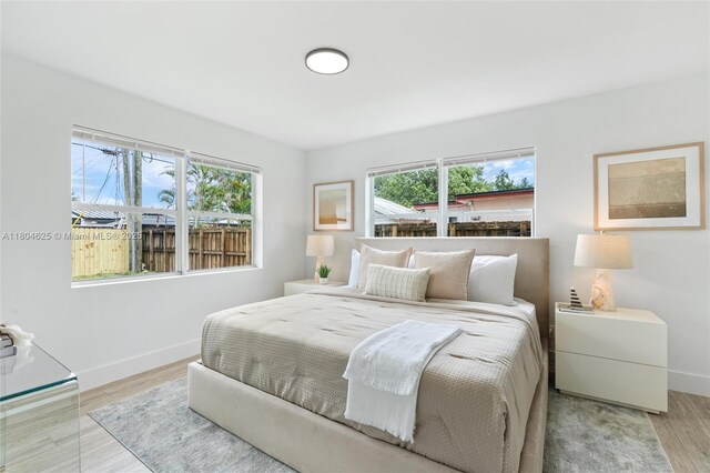 6845 SW 12th St, Pembroke Pines, FL 33023 - bedroom with baseboards and wood finished floors