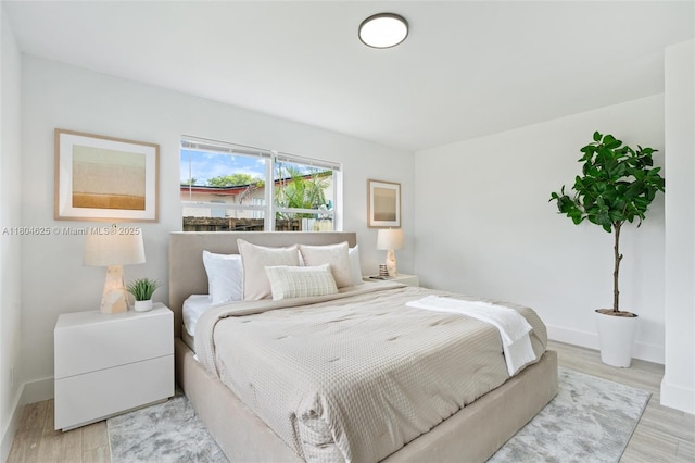 6845 SW 12th St, Pembroke Pines, FL 33023 - bedroom with light wood-style flooring and baseboards