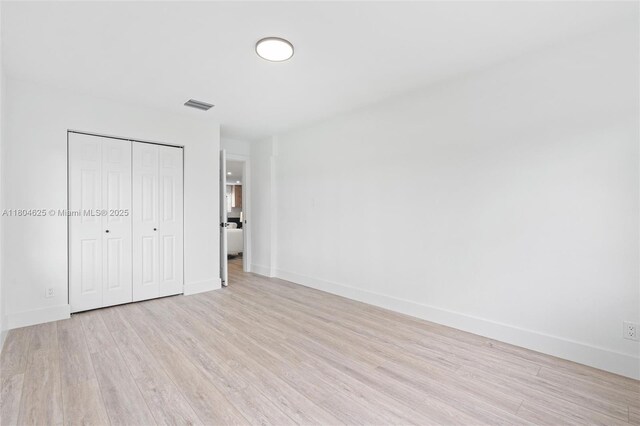 6845 SW 12th St, Pembroke Pines, FL 33023 - unfurnished bedroom featuring light wood-style floors, a closet, and baseboards