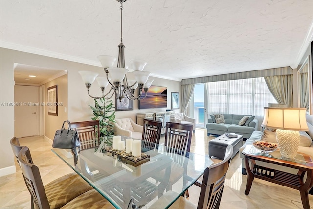 3725 S Ocean Dr Unit 1014, Hollywood, FL 33019 - dining area featuring crown molding, a chandelier, baseboards, and a textured ceiling