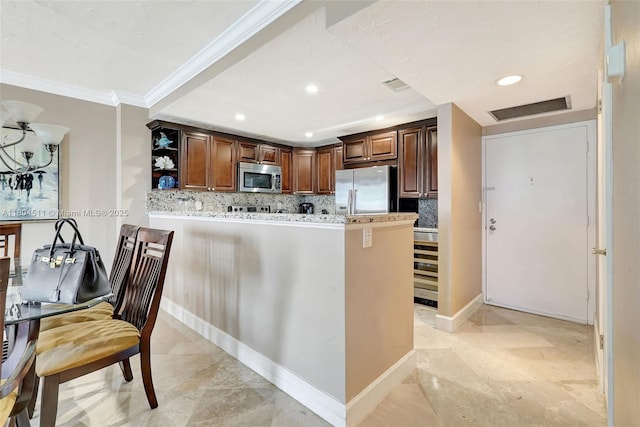 3725 S Ocean Dr Unit 1014, Hollywood, FL 33019 - kitchen with stainless steel appliances, ornamental molding, backsplash, open shelves, and a peninsula