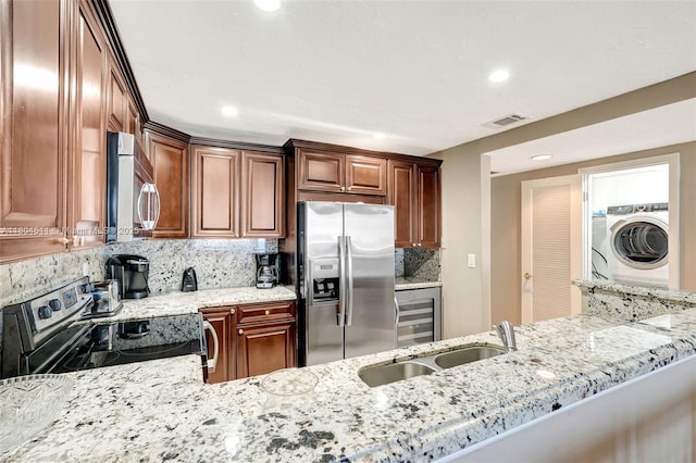 3725 S Ocean Dr Unit 1014, Hollywood, FL 33019 - kitchen featuring appliances with stainless steel finishes, washer / clothes dryer, wine cooler, a sink, and recessed lighting
