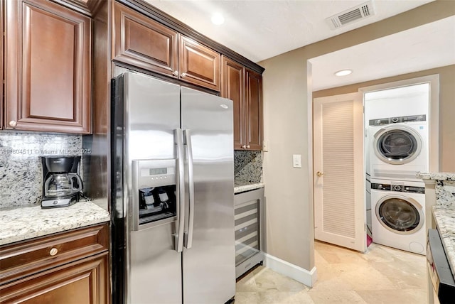 3725 S Ocean Dr Unit 1014, Hollywood, FL 33019 - kitchen with stainless steel fridge, beverage cooler, stacked washing machine and dryer, tasteful backsplash, and recessed lighting