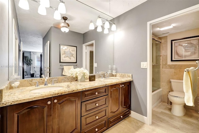 3725 S Ocean Dr Unit 1014, Hollywood, FL 33019 - full bathroom with double vanity, toilet, enclosed tub / shower combo, and baseboards