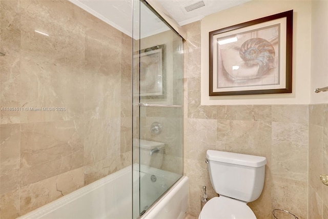 3725 S Ocean Dr Unit 1014, Hollywood, FL 33019 - full bathroom with ornamental molding, bath / shower combo with glass door, toilet, and tile walls