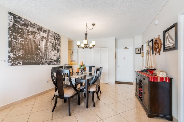 1980 S Ocean Dr Unit 9K, Hallandale Beach, FL 33009 - dining space with a chandelier, light tile patterned flooring, a textured ceiling, and baseboards