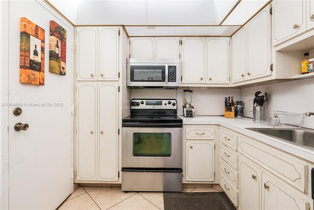 1980 S Ocean Dr Unit 9K, Hallandale Beach, FL 33009 - kitchen featuring stainless steel appliances, light tile patterned floors, light countertops, and a sink