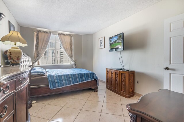 1980 S Ocean Dr Unit 9K, Hallandale Beach, FL 33009 - bedroom featuring a textured ceiling, light tile patterned floors, and baseboards