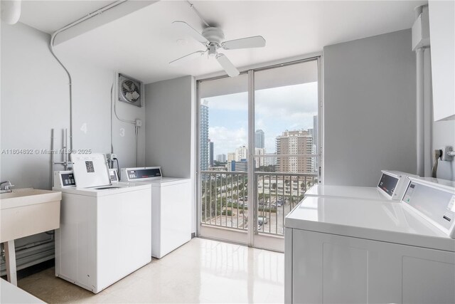 1980 S Ocean Dr Unit 9K, Hallandale Beach, FL 33009 - community laundry featuring independent washer and dryer, ceiling fan, a view of skyline, and light tile patterned floors