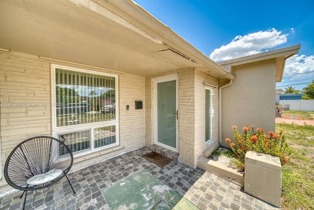 7717 Coral Blvd, Miramar, FL 33023 - doorway to property with a patio area and brick siding