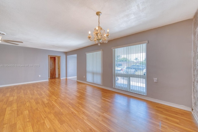 7717 Coral Blvd, Miramar, FL 33023 - spare room featuring a chandelier, light wood finished floors, baseboards, and a textured ceiling