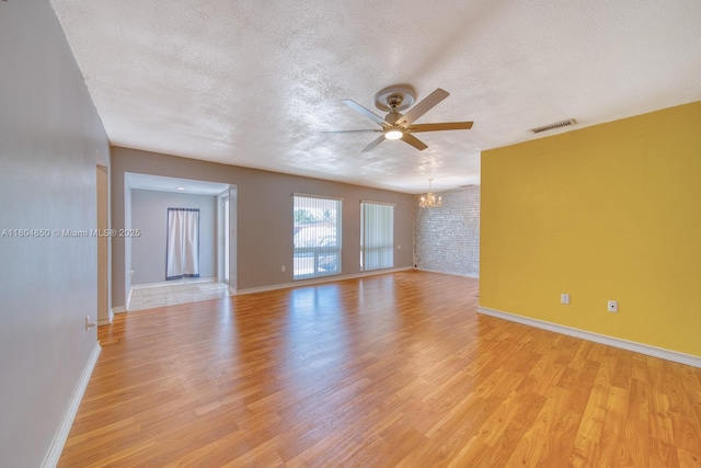 7717 Coral Blvd, Miramar, FL 33023 - empty room featuring a chandelier, a textured ceiling, ceiling fan, light wood-style floors, and baseboards