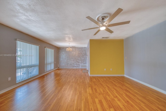 7717 Coral Blvd, Miramar, FL 33023 - unfurnished room featuring a chandelier, light wood-style flooring, a textured ceiling, a ceiling fan, and baseboards