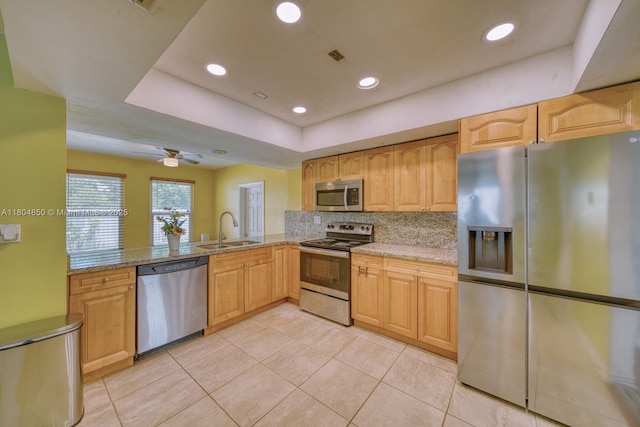 7717 Coral Blvd, Miramar, FL 33023 - kitchen with stainless steel appliances, a sink, light tile patterned flooring, light stone counters, and recessed lighting