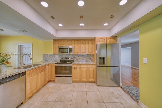 7717 Coral Blvd, Miramar, FL 33023 - kitchen featuring appliances with stainless steel finishes, a sink, light stone counters, backsplash, and light tile patterned floors