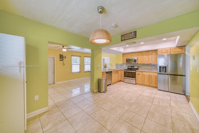 7717 Coral Blvd, Miramar, FL 33023 - kitchen with appliances with stainless steel finishes, light tile patterned floors, decorative backsplash, a sink, and pendant lighting