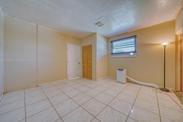 7717 Coral Blvd, Miramar, FL 33023 - unfurnished room with light tile patterned flooring, a textured ceiling, and baseboards
