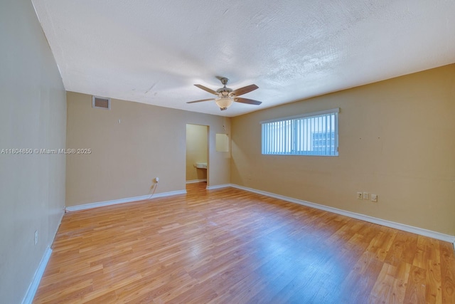 7717 Coral Blvd, Miramar, FL 33023 - empty room featuring light wood-style floors, ceiling fan, baseboards, and a textured ceiling
