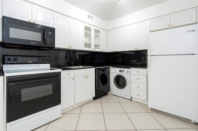 6770 Indian Creek Dr Unit 4P, Miami Beach, FL 33141 - kitchen featuring freestanding refrigerator, black microwave, range with electric stovetop, a sink, and white cabinetry