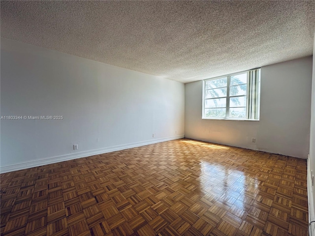 6770 Indian Creek Dr Unit 4P, Miami Beach, FL 33141 - spare room with a textured ceiling and baseboards