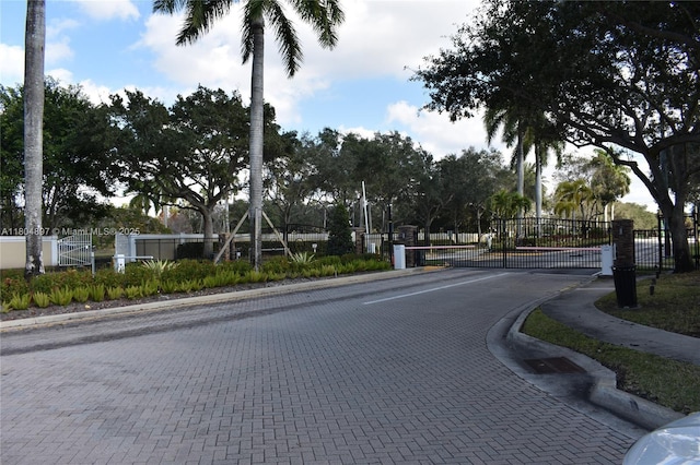 13833 NW 22nd St, Sunrise, FL 33323 - view of road with sidewalks, a gate, and curbs