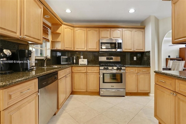 13833 NW 22nd St, Sunrise, FL 33323 - kitchen featuring appliances with stainless steel finishes, a sink, tasteful backsplash, dark stone countertops, and light brown cabinets